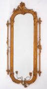 A Victorian gesso and later gilt decorated girandole wall mirror with cartouche foliate and fruit