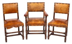 A set of six oak dining chairs in the Cromwellian taste, including a pair of armchairs,