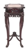 A Chinese carved hardwood jardiniere stand, the top of octofoil outline,