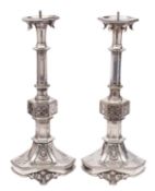 A pair of silver plated metal table lamp bases modelled as pricket sticks in Gothic style,