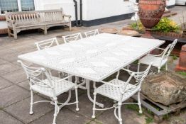 A substantial cream painted metal garden dining table and six elbow chairs,