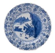 A Chinese blue and white 'hunting' dish, Kangxi with barbed rim,