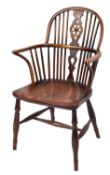 A 19th Century elm, ash and beechwood wheel and stick back Windsor elbow chair,