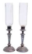 A pair of Victorian Sheffield plate candlesticks with cut glass storm shades,