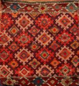 A Turkoman bag, the hooked lozenge field with lozenge guard stripes, 97cm x 89cm, two Nomadic rugs,