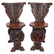 A pair of 19th Century Italian carved oak Scarbello chairs,