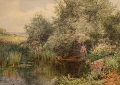 Henry John Sylvester Stannard (British 1870 - 1951) - A pond in summer surrounded by flowers and