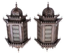 A pair of lacquered metal and glazed wall lanterns, possibly Egyptian,