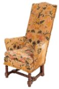 A walnut and beechwood frame high back armchair, in the William and Mary style,