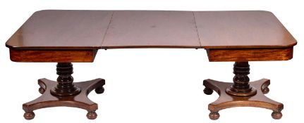 An early 19th Century mahogany twin pillar dining table,