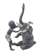 An Austrian cold painted bronze group of an African boy and an elephant calf,