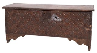A late 17th Century oak rectangular coffer of plank construction, with a hinged moulded top,