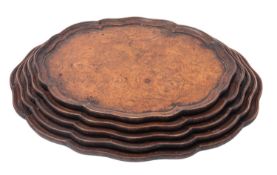 A graduated set of five burr walnut trays,