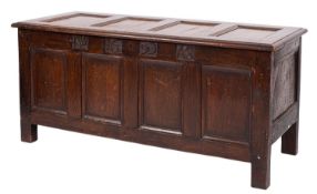 A late 17th century oak rectangular coffer with a 20th century moulded panel hinged top.