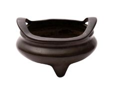 A Chinese bronze tripod censer of bombe form with flattened loop handles,