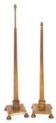 A pair of brass reeded adjustable column standard lamps, on square bases with circular turned feet.