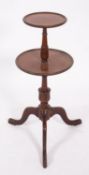 A mahogany circular two tier graduated wine table, in the Georgian style,