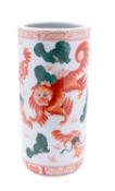 A Chinese porcelain stick stand decorated with numerous lion dogs and seven lines of text,