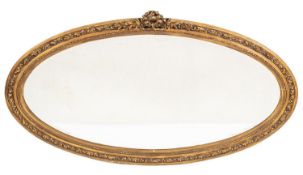 An oval moulded gilt gesso framed wall mirror of large size,