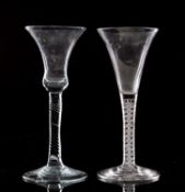 An English wine glass the trumpet shaped bowl set on a straight double series opaque twist stem set