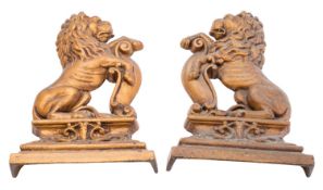 A pair of Victorian painted cast iron door porters modelled as shield bearing lions sejant,