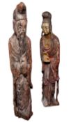 Two Chinese carved wooden figures of deities both in standing posture holding a peach,
