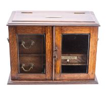 An oak and glazed table top compendium,