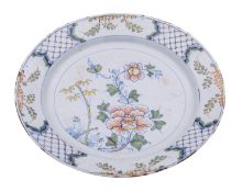 An English polychrome delftware charger, circa 1750 painted in the Chinese manner with peony,
