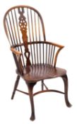 An elm seated Windsor chair, with spindle arched back, central wheel back splat, shaped seat,