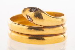 A Victorian diamond snake ring, a coiled snake with two small rose-cut diamonds as eyes, marked 18,