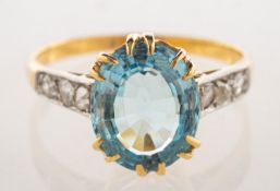 An aquamarine and diamond ring, double claw set with an oval step-cut aquamarine, approx. 2.