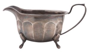 A 20th century silver sauce boat, shaped oval form, with a part-fluted body and on cabriole legs,