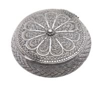 A silver hinged box, circular form, with hatched sides and filigree decoration on the cover & base,