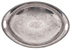 A late Victorian two-handled silver tea tray, of oval outline, with fluted sides,