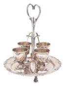 An Edwardian silver egg cruet, of shaped circular outline,