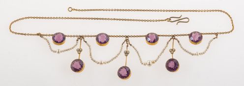 An Edwardian festoon necklace, collet set with circular-cut purple paste stones,