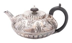 A George III silver tea pot, squat circular form, with a reeded border and a 