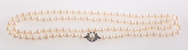 A pearl necklace with sapphire set clasp,
