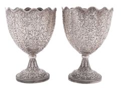A pair of late 19th century Indian silver cups or goblets, of shaped circular outline,