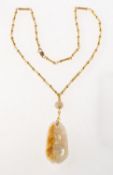 A fancy link chain with a carved jade pendant, (possibly Hetian jade?),