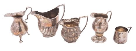 Five silver milk/ cream jugs, one with a fluted lower body,