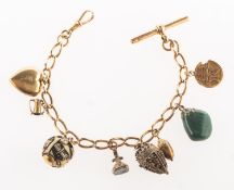 A charm bracelet with charms, the charm bracelet with T-bar and swivel clasp,