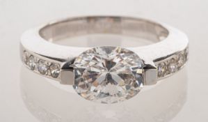 A dress ring, set with an oval-cut paste stone and circular-cut paste stones, marked 14k, size P, 6.