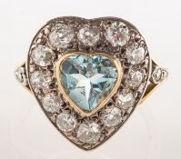A diamond and aquamarine heart shaped ring, collet set to the centre with a heart-shaped aquamarine,