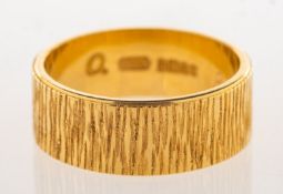A 1970's 22ct gold wedding band, with textured bark effect finish, UK hallmark, Birmingham, 1971,