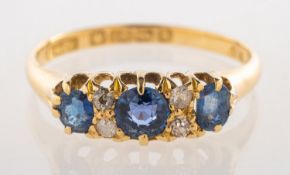 An early 20th century sapphire and diamond ring, of gypsy style,