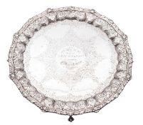 A late Victorian silver salver, of shaped circular outline, with a gadroon & husk border,