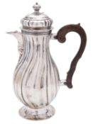 An 18th century German silver jug, of baluster form, with wrythen fluted decoration,