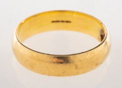 An 18ct gold wedding band, UK import mark 750, sizing beads added inside, size T to T1/2, width 6.