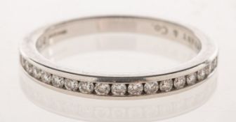Tiffany & Co, A platinum diamond half circle band, a classic Tiffany channel setting,